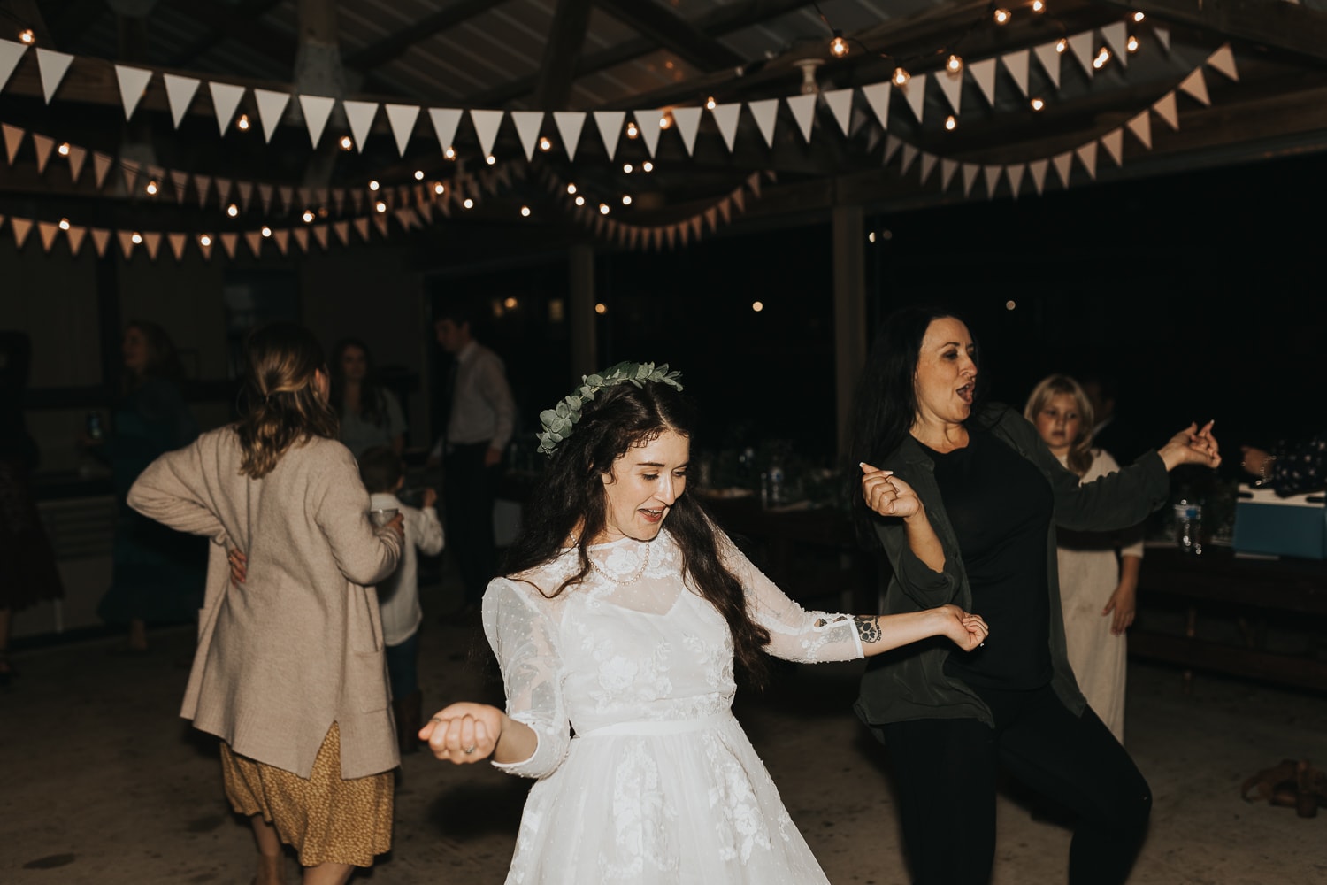 Wedding Photographer, bride dances at her reception with family