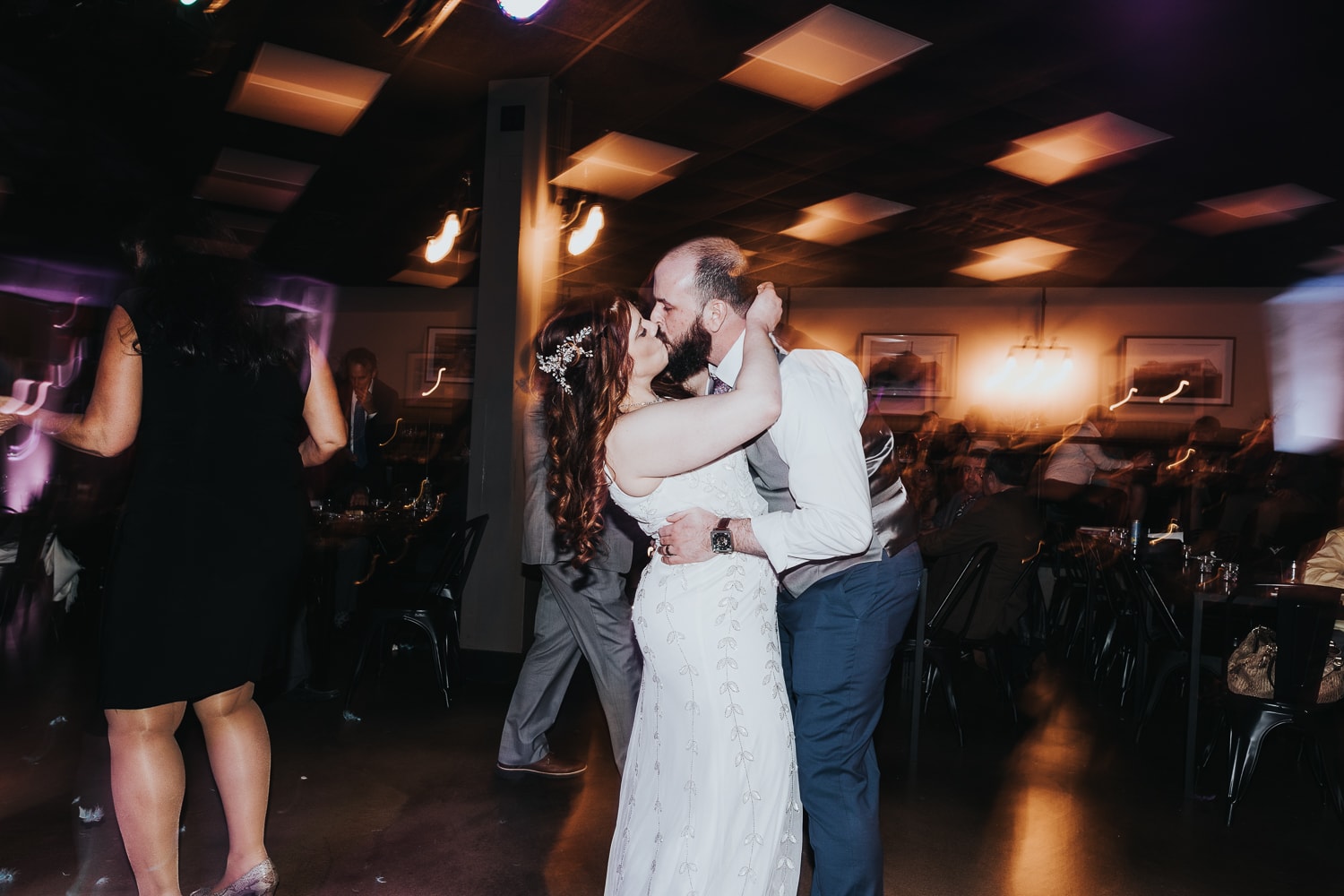 Wedding Photographer, Bride and groom kiss as they dance at their reception